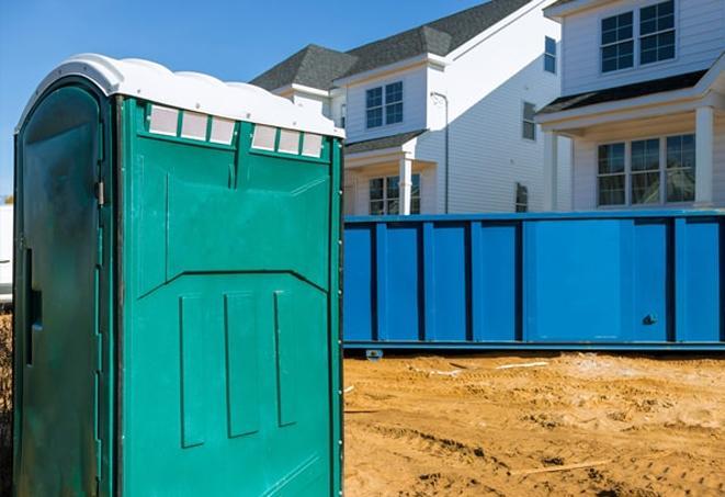 a row of portable toilets located at a busy work site